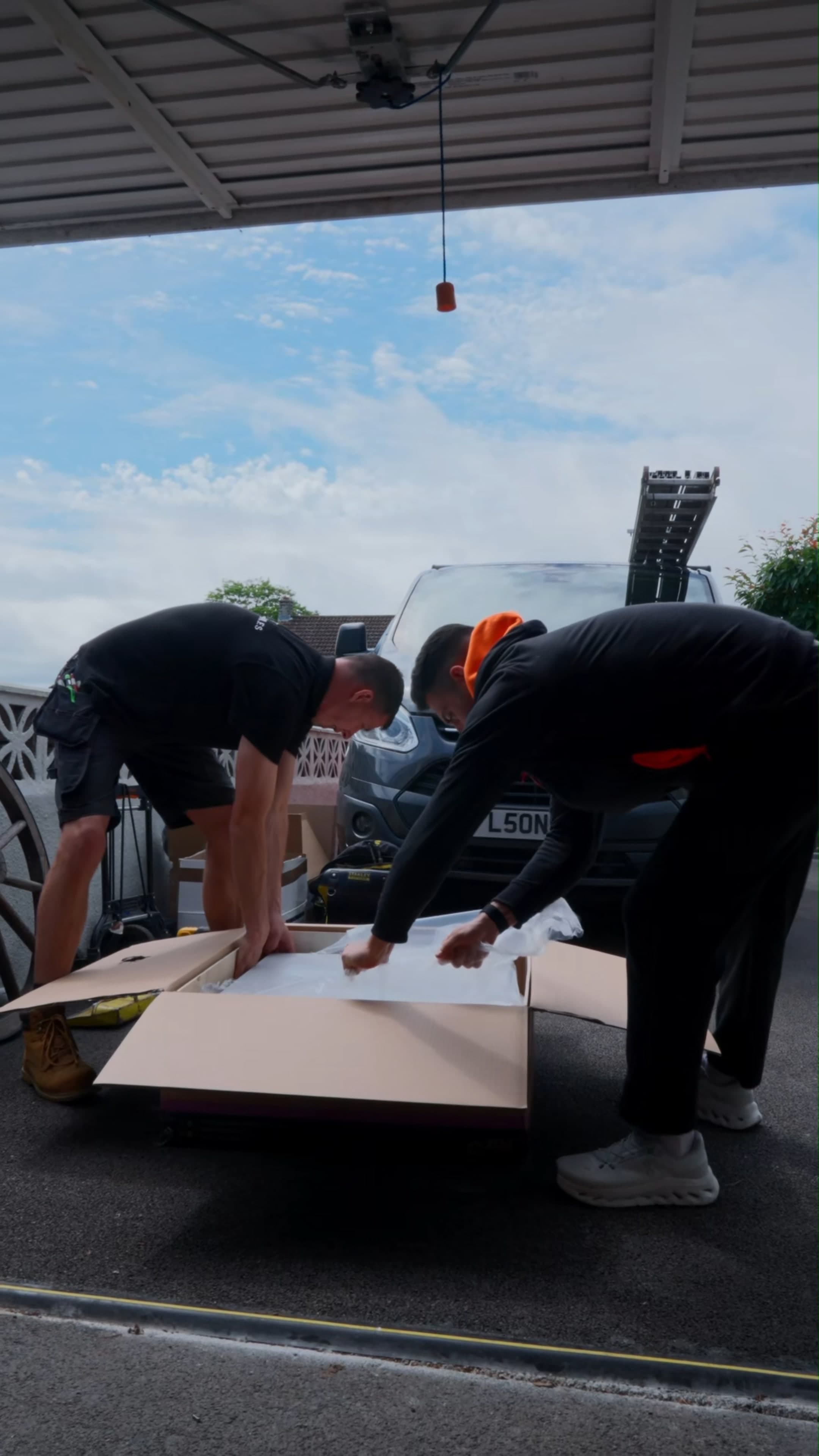 Geko engineers unpacking a panel from delivery ahead of the install